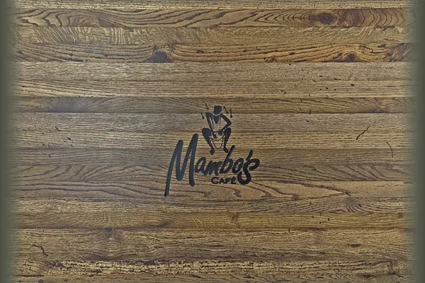 Close-up of logo engraving on a restaurant tabletop.