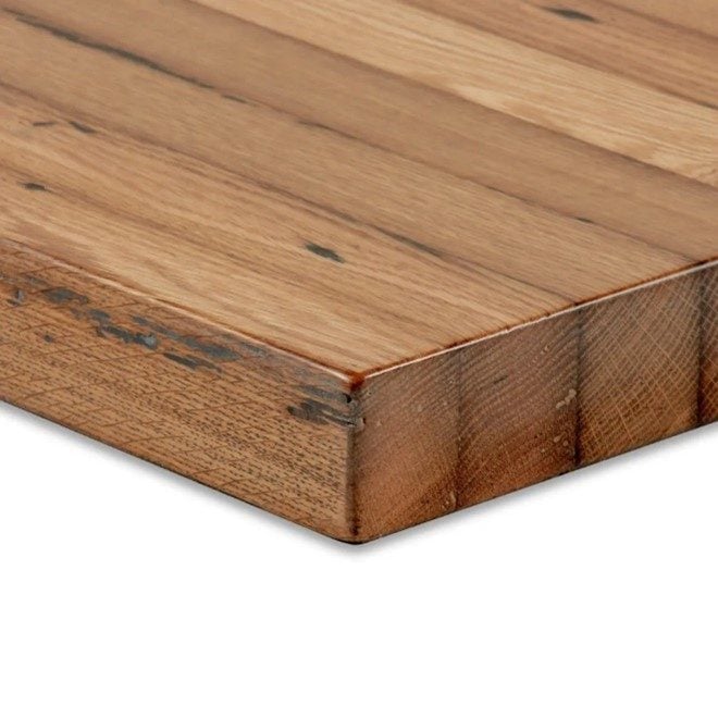 Corner shot of reclaimed oak restaurant table.